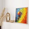 a vibrant painting of fruits, including oranges, grapes, and a kiwi, displayed on a white wall above a wooden shelf.