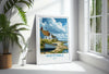 A framed poster of a coastal village in Kent, England, with a boat on the shore and a cloudy sky in the background.