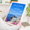 a person holding a tablet with a picture of a city on it