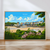 The image is a framed poster depicting a coastal town with colorful buildings, a sandy beach, and a body of water in the background.