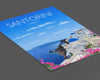 a brochure with a picture of a town on a cliff